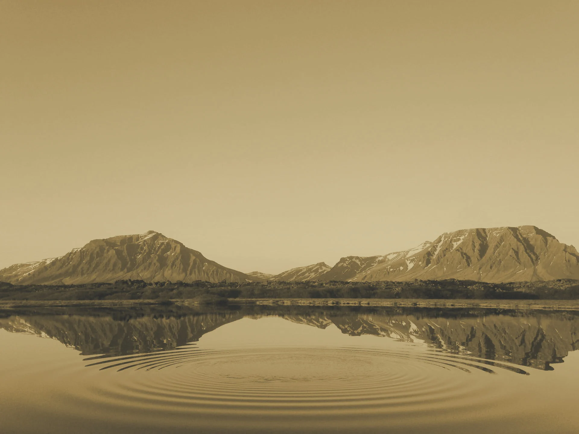 Snow-capped mountains mirrored in a calm lake