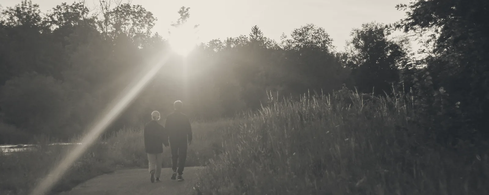 A family walking along a path in sunlight symbolising financial turning points in life