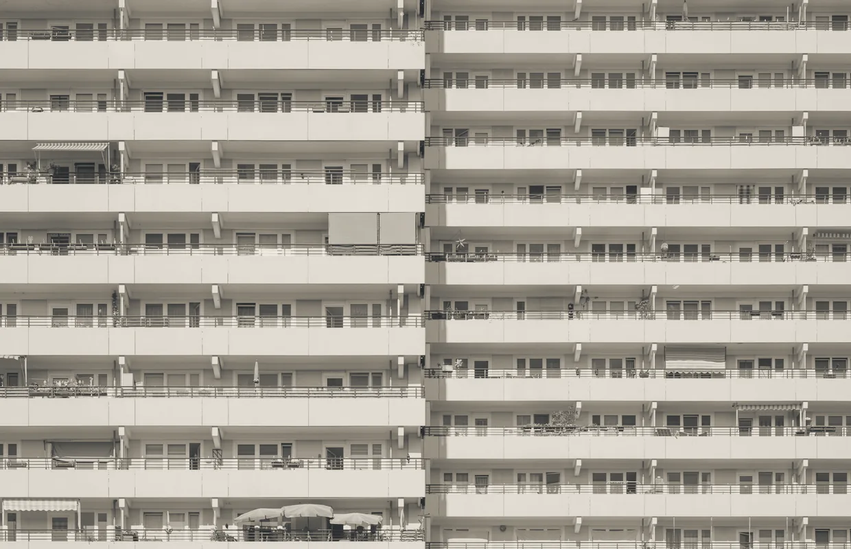 Facade of a residential building with evenly spaced balconies